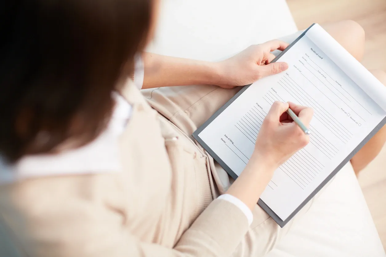 Person writing in a journal during therapy